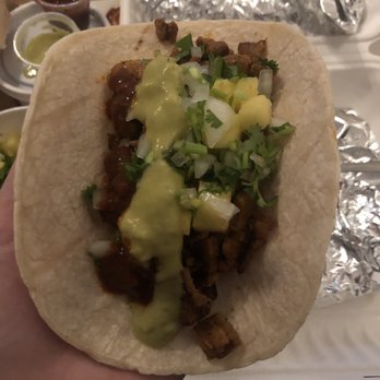 Ta Chido - a hand holding a taco with meat and cheese - Mexican Near Me - Montreal, Quebec