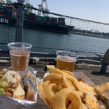 Vicky's Doghouse - The Battlewagon (left), The Destroyer (right), onion rings, two 805 beers, and a pretty excellent view - Hot Dogs Near Me - San Pedro, California