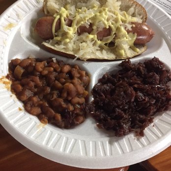 Hermann Wurst Haus - Brat on a pretzel bun with baked beans and red cabbage - Meat Shops Near Me - Hermann, Missouri Hermann Wurst Haus - Brat on a pretzel bun with baked beans and red cabbage - Meat Shops Near Me - Hermann, Missouri