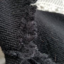 What was once beautiful fringe made of individual yarn strands is now frizzy fuzz! Notice that gross hair, too! (It's not mine!)