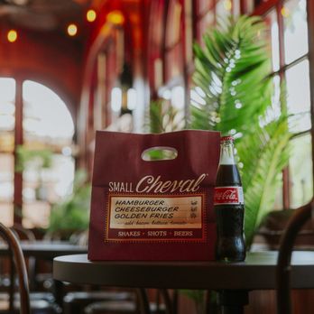 Small Cheval- Wilmette - A bag of Small Cheval with a Coca Cola, located in Small Cheval Wilmette - Fast Food Near Me - Wilmette, Illinois
