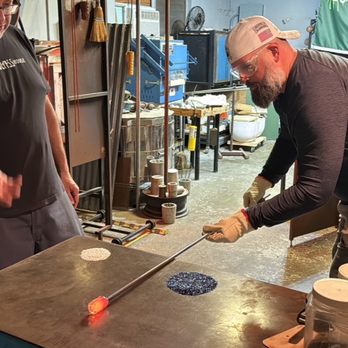 Florida Glass House - Rolling molten glass to create center foundation of flower. - Art Supplies Near Me - Orlando, Florida Florida Glass House - Rolling molten glass to create center foundation of flower. - Art Supplies Near Me - Orlando, Florida