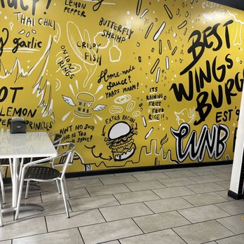 WNB Factory - a yellow wall covered in graffiti - Burgers Near Me - Newnan, Georgia WNB Factory - a yellow wall covered in graffiti - Burgers Near Me - Newnan, Georgia