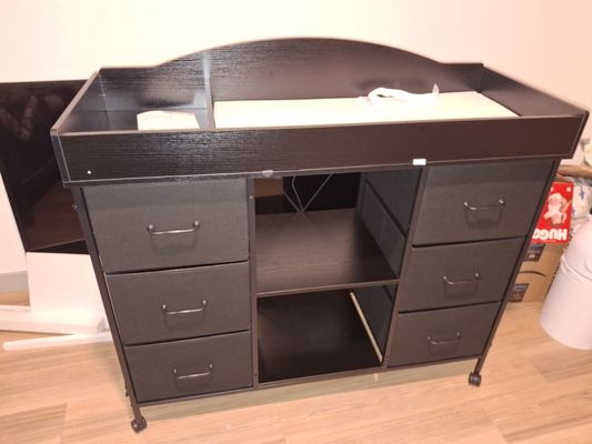 Baby changing table - Assembling a baby changing table involves creating a stable, upright frame, usually constructed from wood or metal, with securely attached shelving and a safety-focused, raised-edge top surface for a changing pad. Key steps include organizing hardware, assembling side frames, connecting them with horizontal shelves for stability, and ensuring all fasteners are tightened for safety.