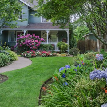Zark's Outdoor Solutions - a front yard with flowers and shrubs - Landscaping Near Me Zark's Outdoor Solutions - a front yard with flowers and shrubs - Landscaping Near Me