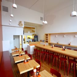 Chuckanut Builders - Bowling alley slab countertops, bright white walls and fun accents make the Dashi Noodle Bar space inviting. Photo by Chuckanut Builders.