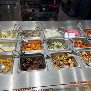 Mezeh - Took pics of the add-in ingredients. LOTS OF ADD-INS to choose from. Servers are generous with their portions. - Mediterranean Near Me - Blacksburg, Virginia Mezeh - Took pics of the add-in ingredients. LOTS OF ADD-INS to choose from. Servers are generous with their portions. - Mediterranean Near Me - Blacksburg, Virginia