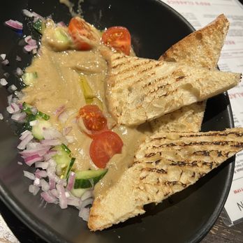 Red’s Kitchen + Tavern - Baba Ghanoush. Came with 4 slices of bread but 1-2 more would help to finish the plates deliciousness. Very tasty app. - American Near Me - Seabrook, New Hampshire