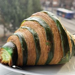 Artisserie Fine Bakery - Check out the layers and the perfect stripes on this pistachio croissant!