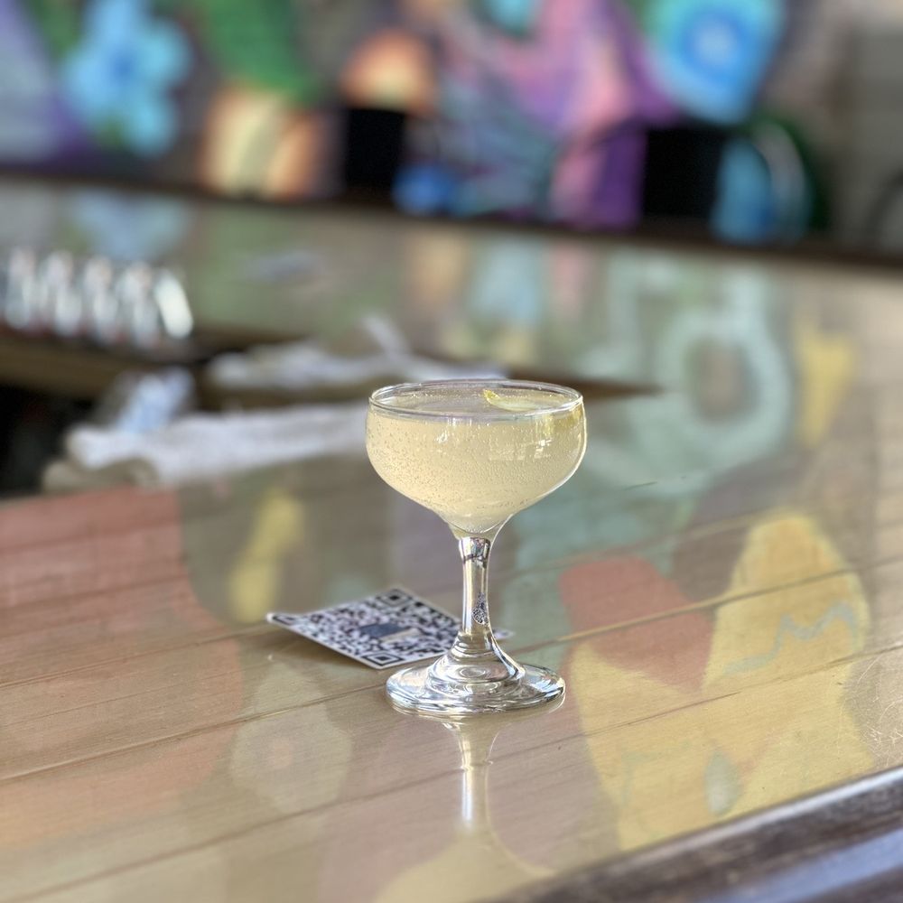 a glass of wine on a bar a glass of wine on a bar