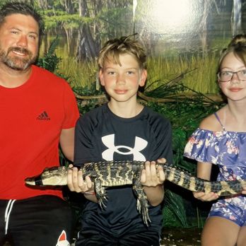 Fudpucker's - Photo with the baby gator - Seafood Near Me - Destin, Florida