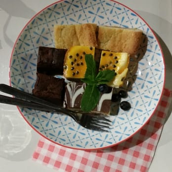 KeK Coffee & Crafts - A lovely sampler of desserts: passion fruit cheesecake, brownie, butter/sugar bar cookie, and chocolate-caramel shortbread. - Coffee & Tea Near Me - Delft, ZH KeK Coffee & Crafts - A lovely sampler of desserts: passion fruit cheesecake, brownie, butter/sugar bar cookie, and chocolate-caramel shortbread. - Coffee & Tea Near Me - Delft, ZH