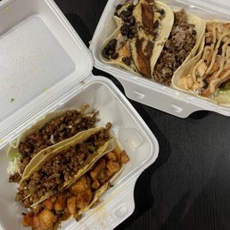 a couple of tacos in a styrofoam container a couple of tacos in a styrofoam container