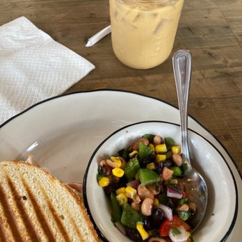 Midtown Coffee House - Turkey panini on gf bread, cowboy caviar and a honey Oatmilk coldbrew - Coffee & Tea Near Me - Columbus, Georgia