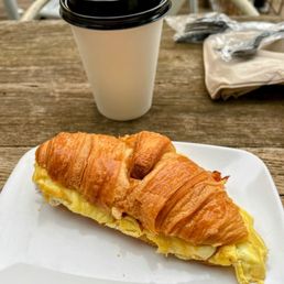 Bacon and egg sandwich with a flat white