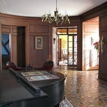 Palmer Woods Historic District - a grand piano in the living room - Music Venues Near Me