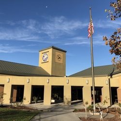 Clara Barton Elementary School - School front with clock tower and flag.