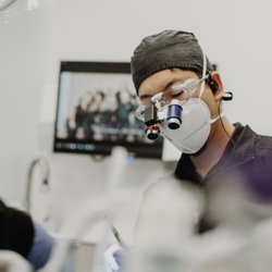 Distinctive Dentistry by Mullens & Nguyen - Dr. Nguyen examining patient