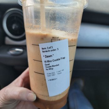 Starbucks - a hand holding a cup of iced coffee - Coffee & Tea Near Me - Bloomington, Indiana Starbucks - a hand holding a cup of iced coffee - Coffee & Tea Near Me - Bloomington, Indiana
