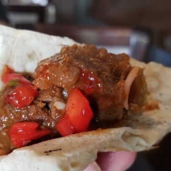 Aman's Indian Bistro - a hand holding a pita - Indian Near Me - Chalfont, Pennsylvania