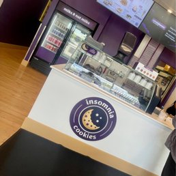 a woman standing in front of a counter