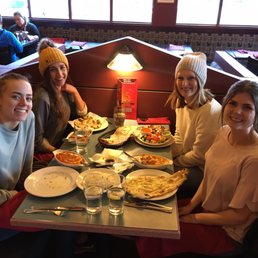 Me and my friends with our incredible dishes. Mine was chicken korma with garlic naan. (Closest on the right).