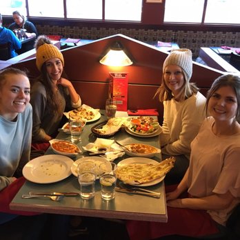 Spice Hut - Me and my friends with our incredible dishes. Mine was chicken korma with garlic naan. (Closest on the right). - Indian Near Me - Canmore, Alberta