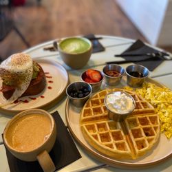 Hybrid Coffee & Kitchen - Loaded Avocado Toast , Belgium Waffles and scrambled eggs with toppings on the side. Matcha Latte and Cappuccino.