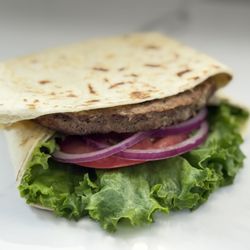 Savannah's Eats & Treats - Burger wrap with cheese sauce onion tomato and lettuce on flour tortilla