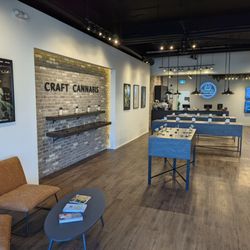 Local Cannabis Co. - Interior of Local Cannabis Co. store showcasing a sensory bar with 'CRAFT CANNABIS' written on a brick wall.