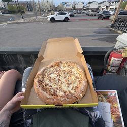 Hungry Howie's Pizza - 0.5 of good pizza on couch in truck in front of howies