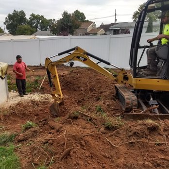 Greener Solutions Landscaping - a man standing next to a bulldozer - Snow Removal Near Me Greener Solutions Landscaping - a man standing next to a bulldozer - Snow Removal Near Me
