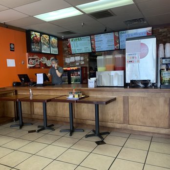 J Buffalo Wings - a man sitting at the counter - New American Near Me - Decatur, Georgia