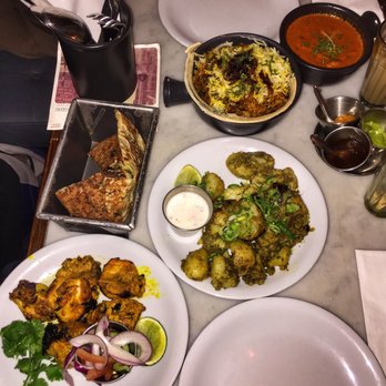 Dishoom - 1) Dishoom Chicken Tikka, 2) Cheese Naan, 3) Vegetable Biryani, 4) Chicken Ruby, and 5) Gunpowder Potatoes. - Indian Near Me - London, XGL Dishoom - 1) Dishoom Chicken Tikka, 2) Cheese Naan, 3) Vegetable Biryani, 4) Chicken Ruby, and 5) Gunpowder Potatoes. - Indian Near Me - London, XGL