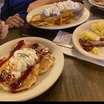 Abracadabra's - Fruity pebbles pancakes  Peach cobbler French toast with bacon and eggs and plain French toast in the back - Breakfast & Brunch Near Me - Idaho Falls, Idaho