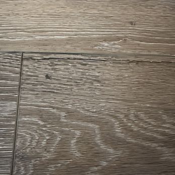 Trucor Construction - Cracking vinyl floor plank with an attempt at a patch by drilled a hole and injecting material underneath. - General Contractors Near Me - Huntington Beach, California Trucor Construction - Cracking vinyl floor plank with an attempt at a patch by drilled a hole and injecting material underneath. - General Contractors Near Me - Huntington Beach, California