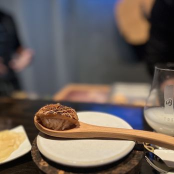 Toshokan - a wooden spoon with food on it - Sushi Bars Near Me - Austin, Texas