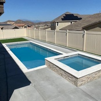 Quality Custom Pools - 12 X 35 pool w/ baja step, aqua while pebble plaster, and limestone coping & spa, concrete around - Pool & Hot Tub Service Near Me - Menifee, California