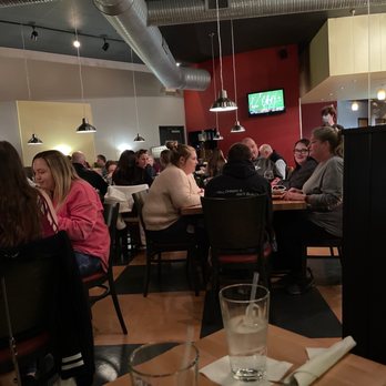 Dewey's Pizza - a group of people sitting at a table - Pizza Near Me - Dayton, Ohio Dewey's Pizza - a group of people sitting at a table - Pizza Near Me - Dayton, Ohio