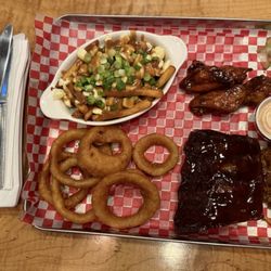 Smoke On The Water - Sampler plate including 1/3 rack ribs, pulled pork, smoked wings, onion rings and side poutine. Everything was amazing.