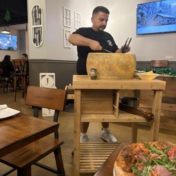 Cheese Wheel Pasta & Pizza - Chef/ owner doing the pasta in the cheese wheel - Pizza Near Me - Clearwater, Florida Cheese Wheel Pasta & Pizza - Chef/ owner doing the pasta in the cheese wheel - Pizza Near Me - Clearwater, Florida