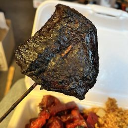 Burnt teriyaki on  a stick. So burnt it was black! Texture of jerky.