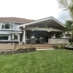 Urban Oasis Design & Construction - View from the yard of the new deck, outdoor kitchen and hot tub