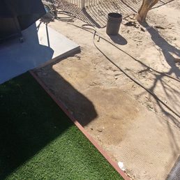 The turf should end at the end of the concrete not in the middle