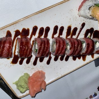 Ocean Prime - a plate of sushi with sauce on it - Seafood Near Me - Phoenix, Arizona