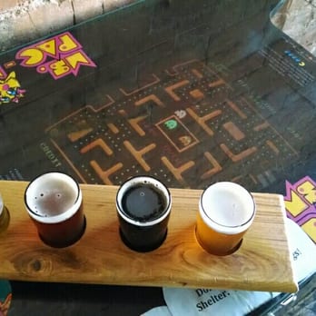 Tap & Bottle - A flight on their vintage Ms. Pacman table. - Wine Bars Near Me - Tucson, Arizona Tap & Bottle - A flight on their vintage Ms. Pacman table. - Wine Bars Near Me - Tucson, Arizona