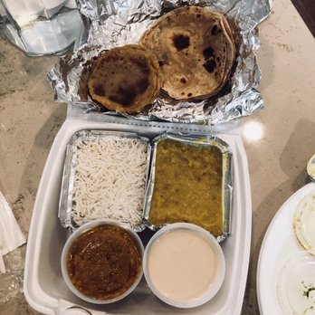Maharaja Bhog - Top: Puran Puri (L), Roti (R) Middle: Steamed rice, moong Daal khichdi Bottom: Mohanthal Halva (L), Apple Basundi (R) - Indian Near Me - Houston, Texas