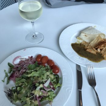 The Centurion Lounge - First course salad with mustard dressing, pickled onions and grape tomatoes.  Chips and a hit green chili.  Glass of NZ Sauvignon Blanc. - Airport Lounges Near Me - Dallas, Texas