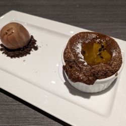 Piaf - Dessert. Dark chocolate souffle served with passionfruit sauce. $300.