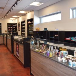 High Plainz Strains Dispensary - A photo of the interior of the store, showing several of the shelves and display cases.